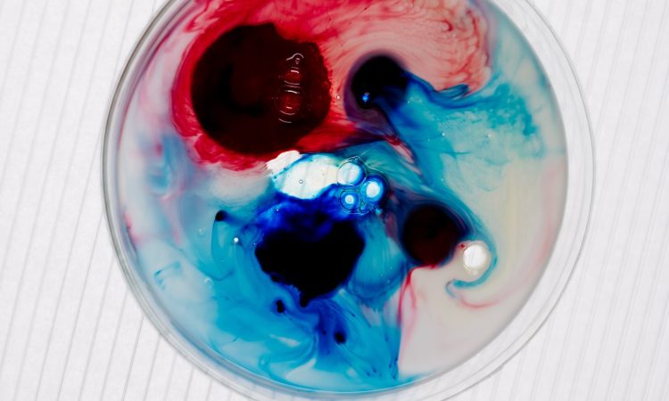 an above shot of two colour liquid in a petri dish