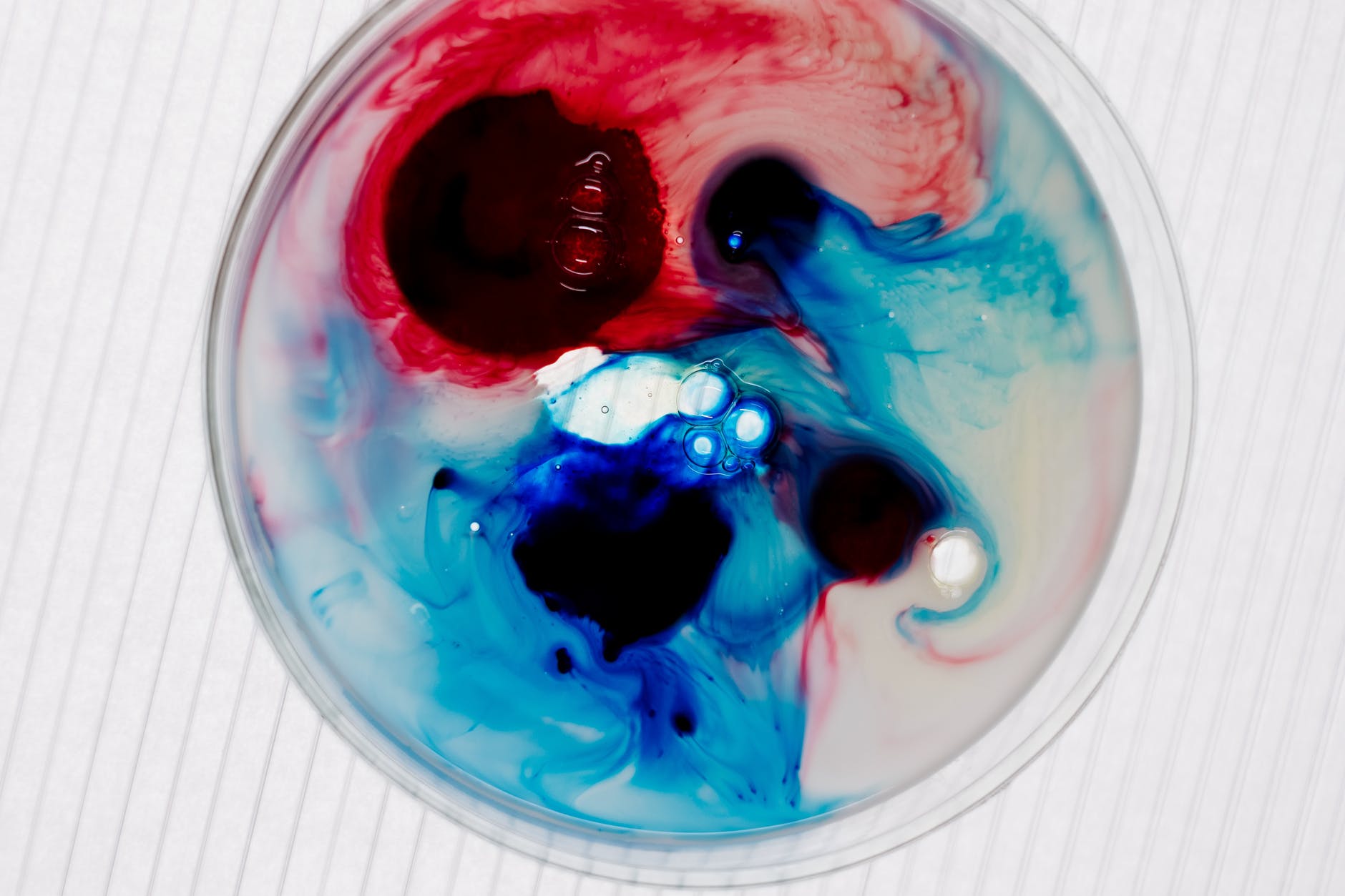 an above shot of two colour liquid in a petri dish